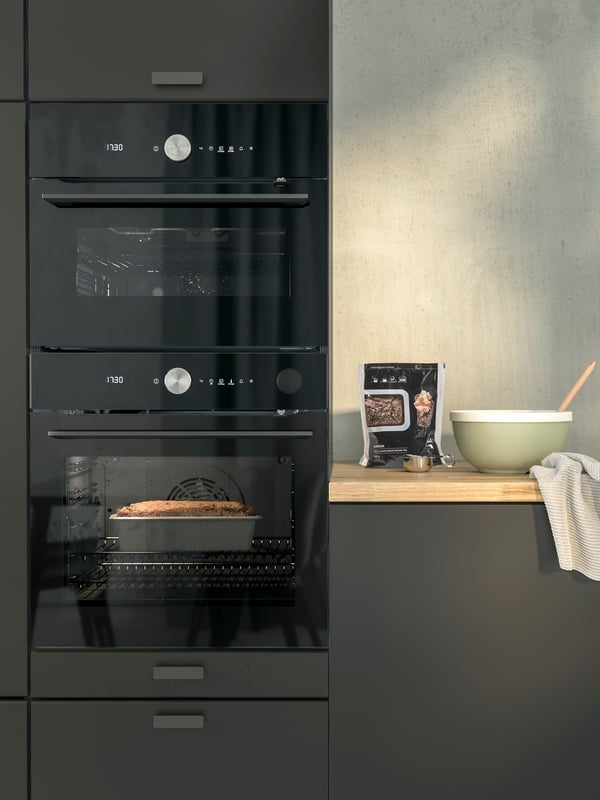 A FINSMAKARE forced-air oven with pyrolytic function in black and a FINSMAKARE microwave combi forced-air oven in black.