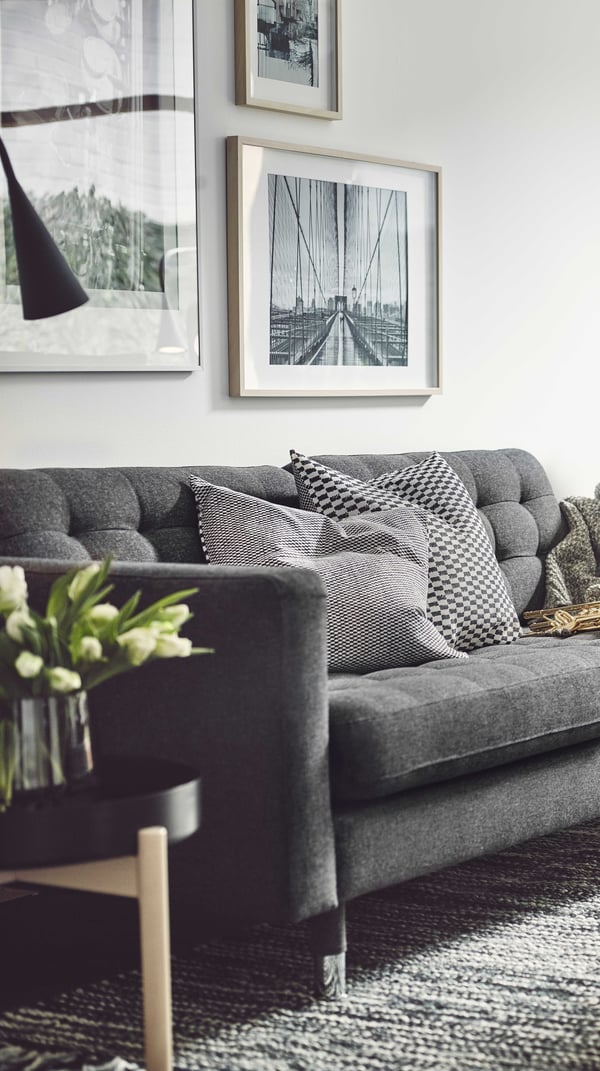 A grey LANDSKRONA sofa with pillows in various sizes and colors.