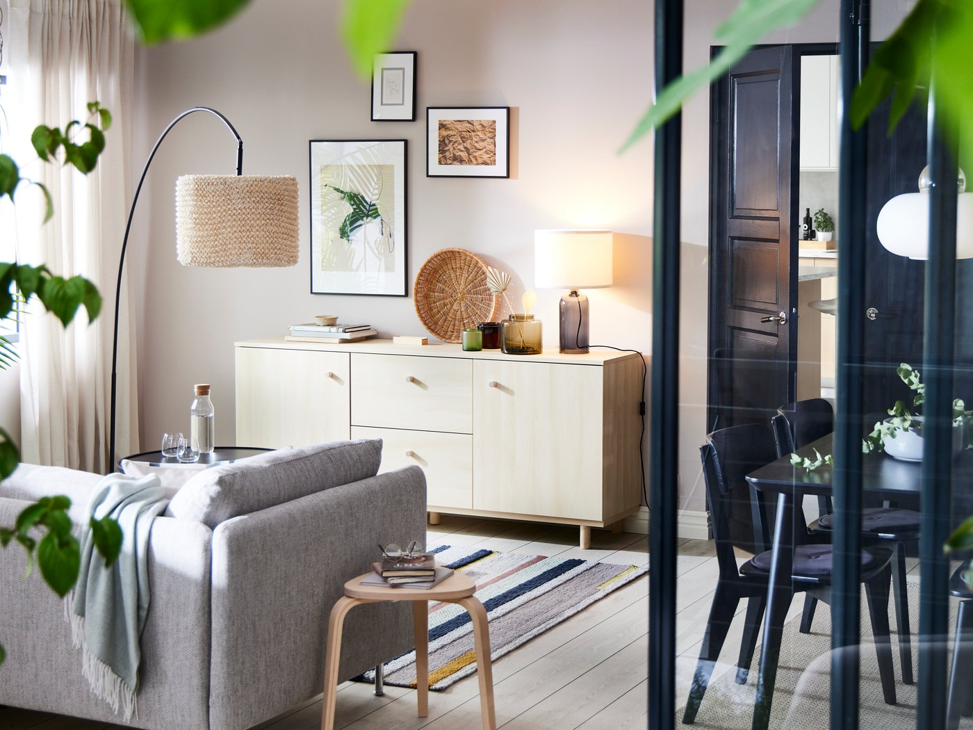 A birch-effect ERSNÄS sideboard against a white wall with a beige/brown SÖDERHAMN sofa and a floor lamp in front of it.