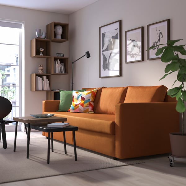 A Faringe brown-orange FRIHETEN 3-seat sofa-bed in the living room