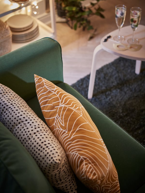 SVAMPMAL pillows on top of a grey turquoise PÄRUP sofa