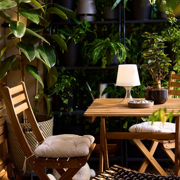 An in/outdoor dark grey/beige RÅGKORN plant pot outside