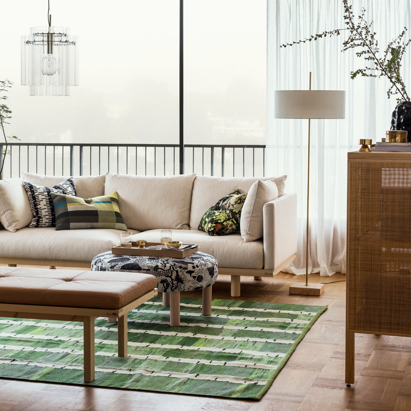 An off-white/black STOCKHOLM 2025 cushion cover in the living room