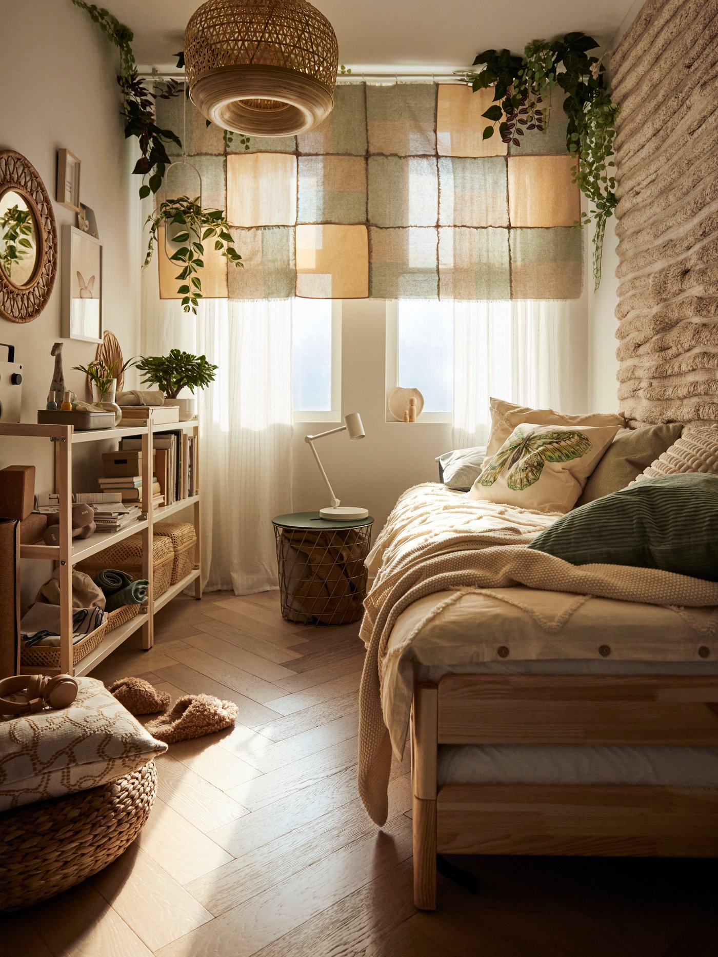 A dreamy teen bedroom in tropical boho style, featuring warm colours, a wall-hung rug, and plenty of wooden accents.