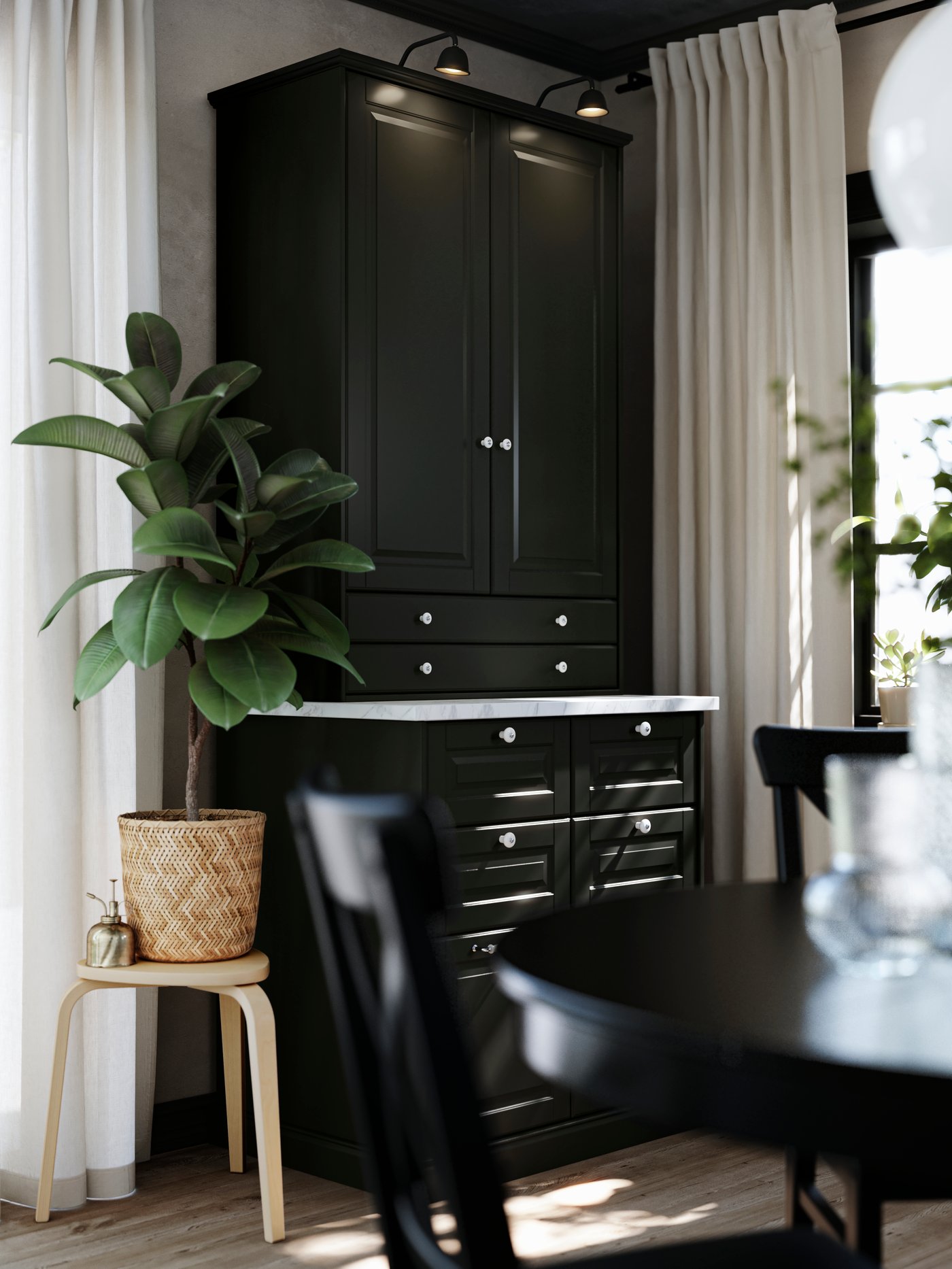 A dining room cabinet, made of METOD kitchen cabinets with traditional black BODBYN fronts, is standing in a dining area.