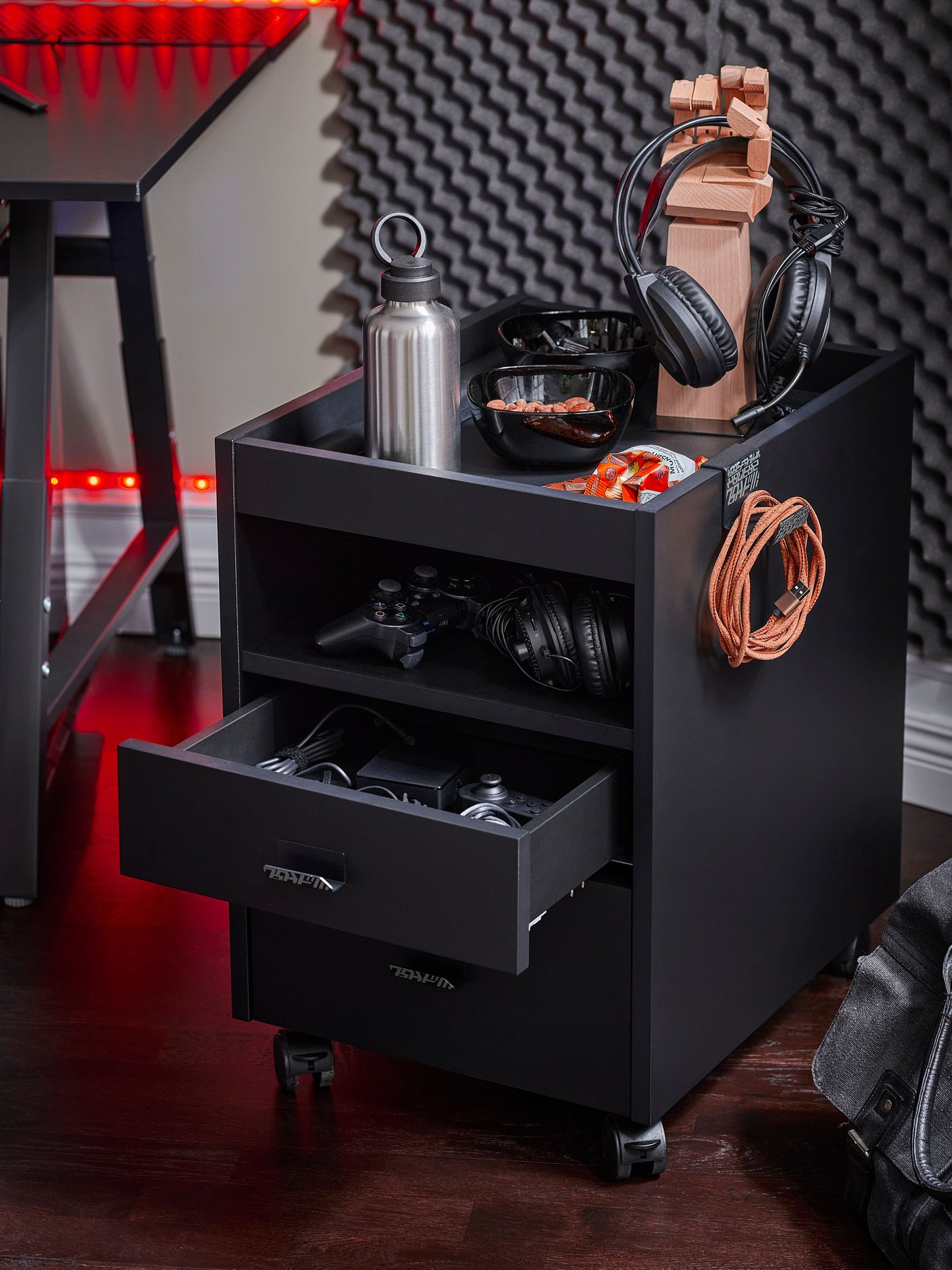 An IKEA UTESPELARE drawer unit on castors beside a gaming desk.