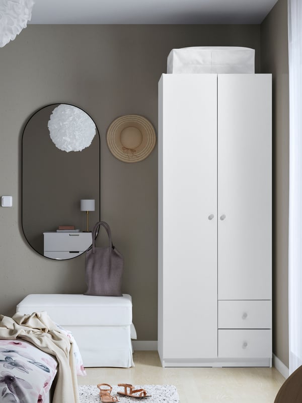 A white BRUKSVARA wardrobe with 2 doors and 2 drawers in the bedroom