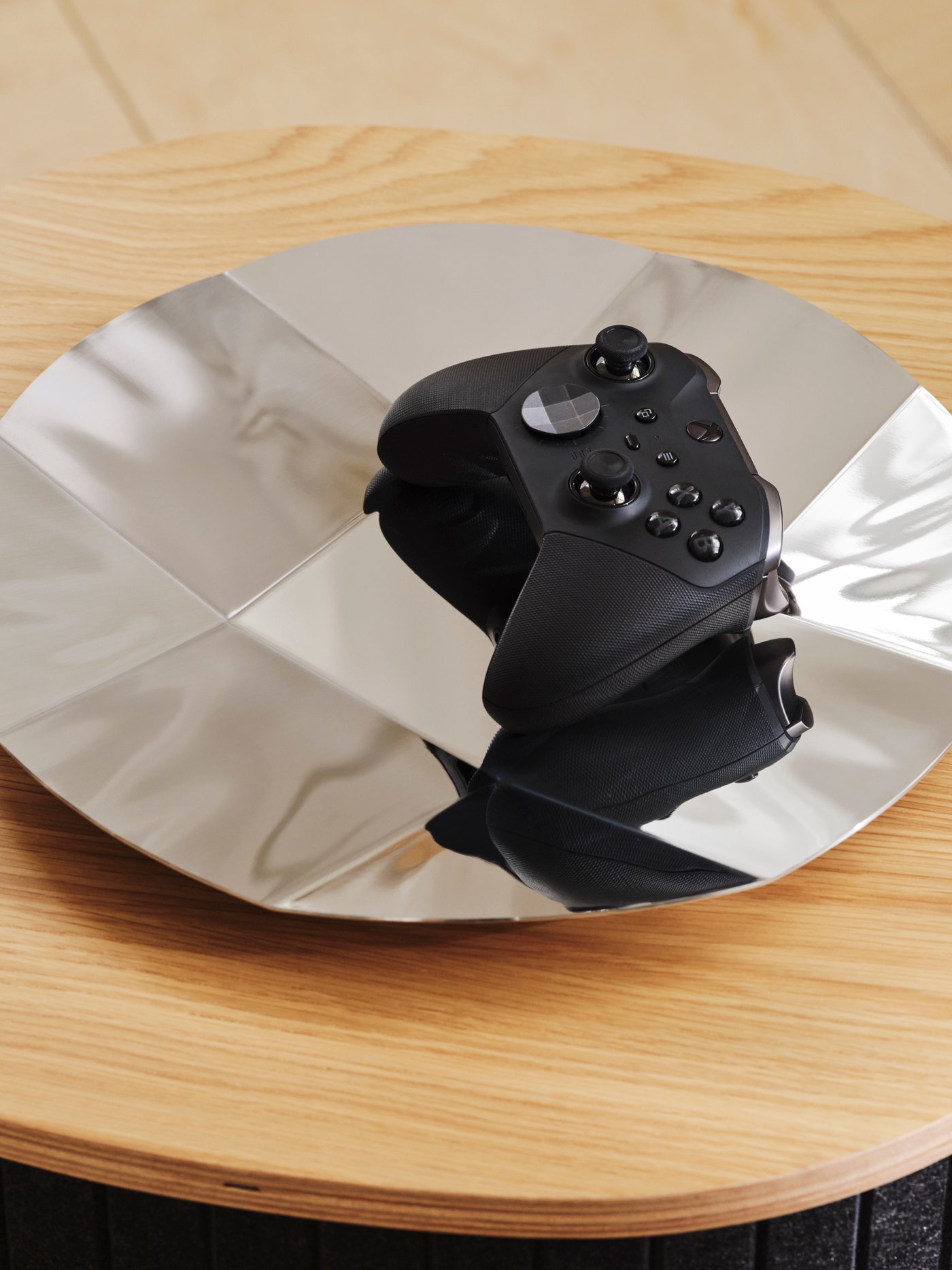 Close-up of an YXSTABY gaming D-pad controller platter holding a black XBOX controller.