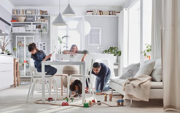 A white BERGSHULT shelf in the living room