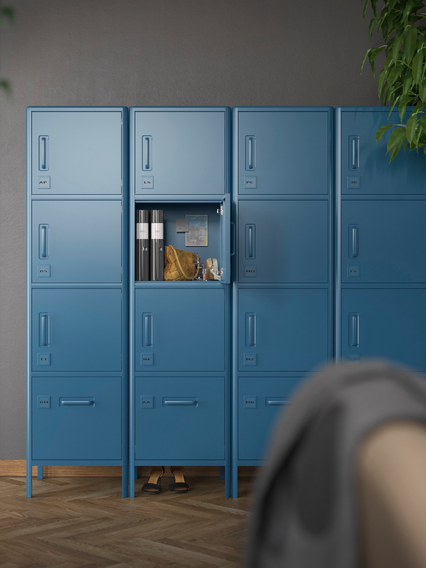 Blue closed storage cabinets against a greyish wall, one of the doors open with files, a bag and various items inside.