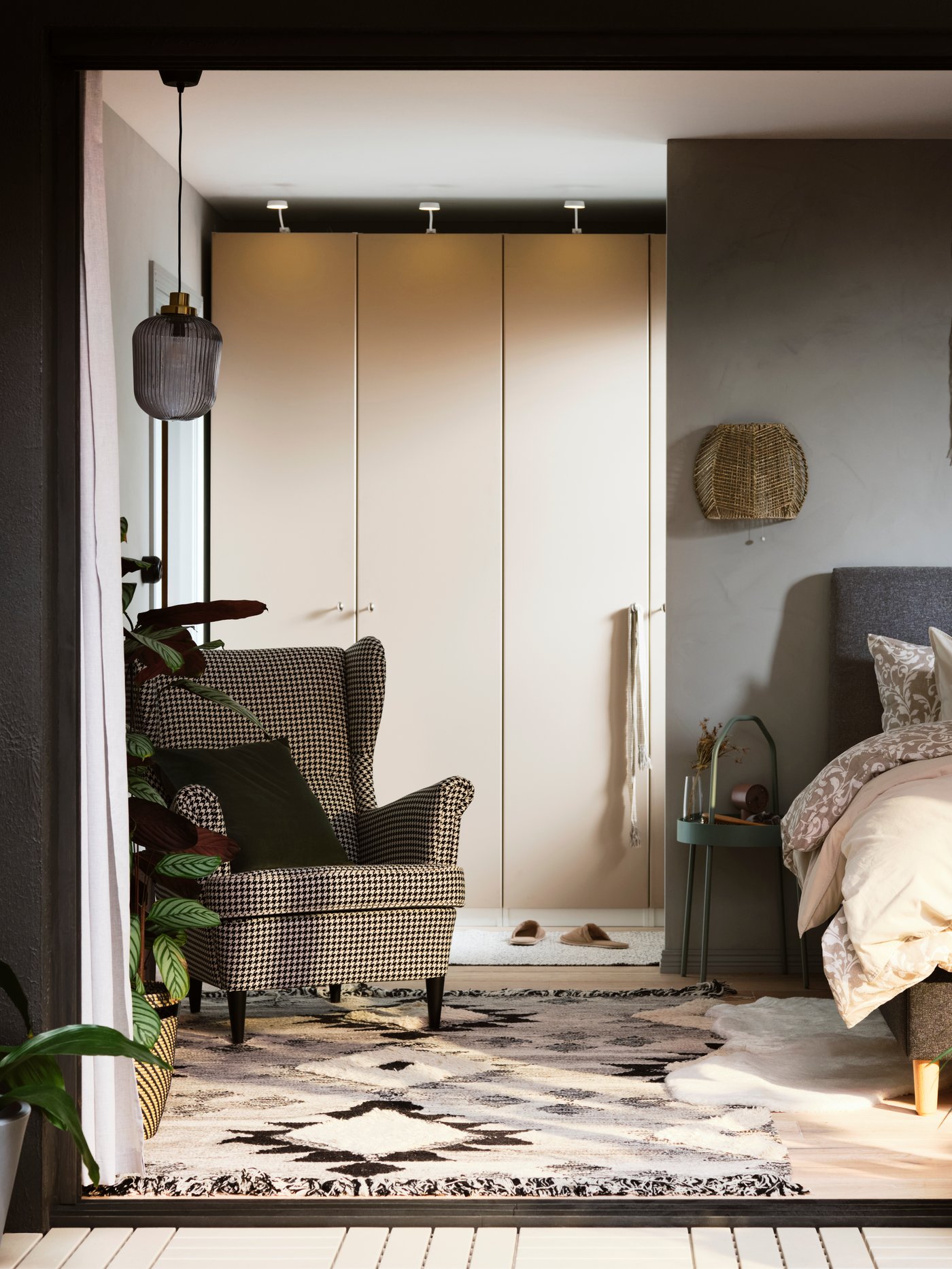 A light grey-green BURVIK side table in the bedroom
