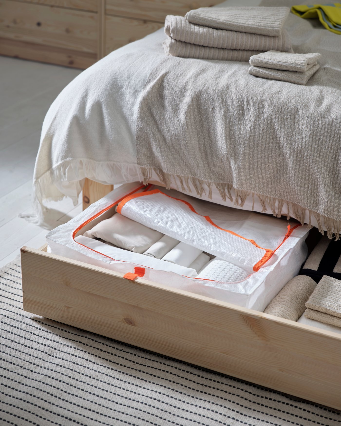 A pine GLAMBERGET extendable bed with storage in the bedroom