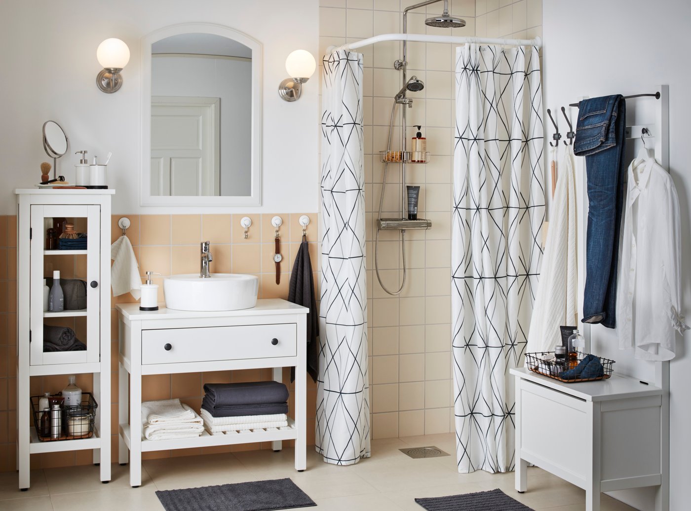 A white HEMNES high cabinet with glass door in the bathroom