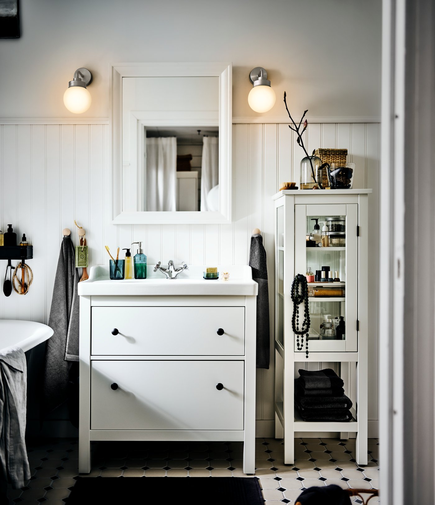A black FRIHULT wall lamp in the bathroom