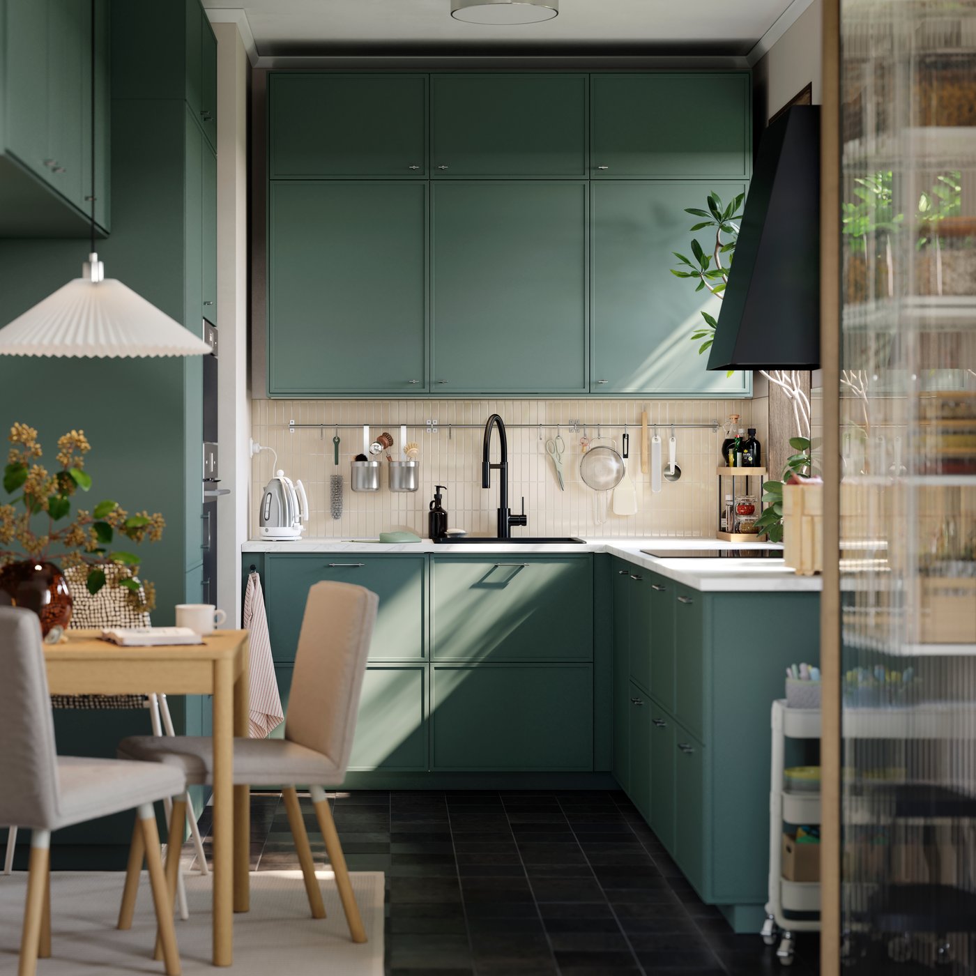 A small kitchen has base, wall and top cabinets, going all the way to the ceiling and there’s a small table with a chair.
