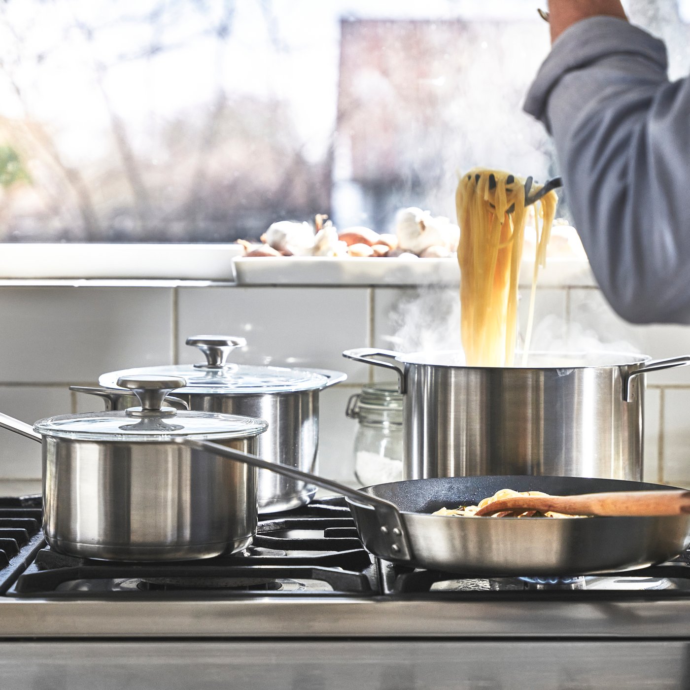 A stainless steel HEMKOMST 7-piece cookware set