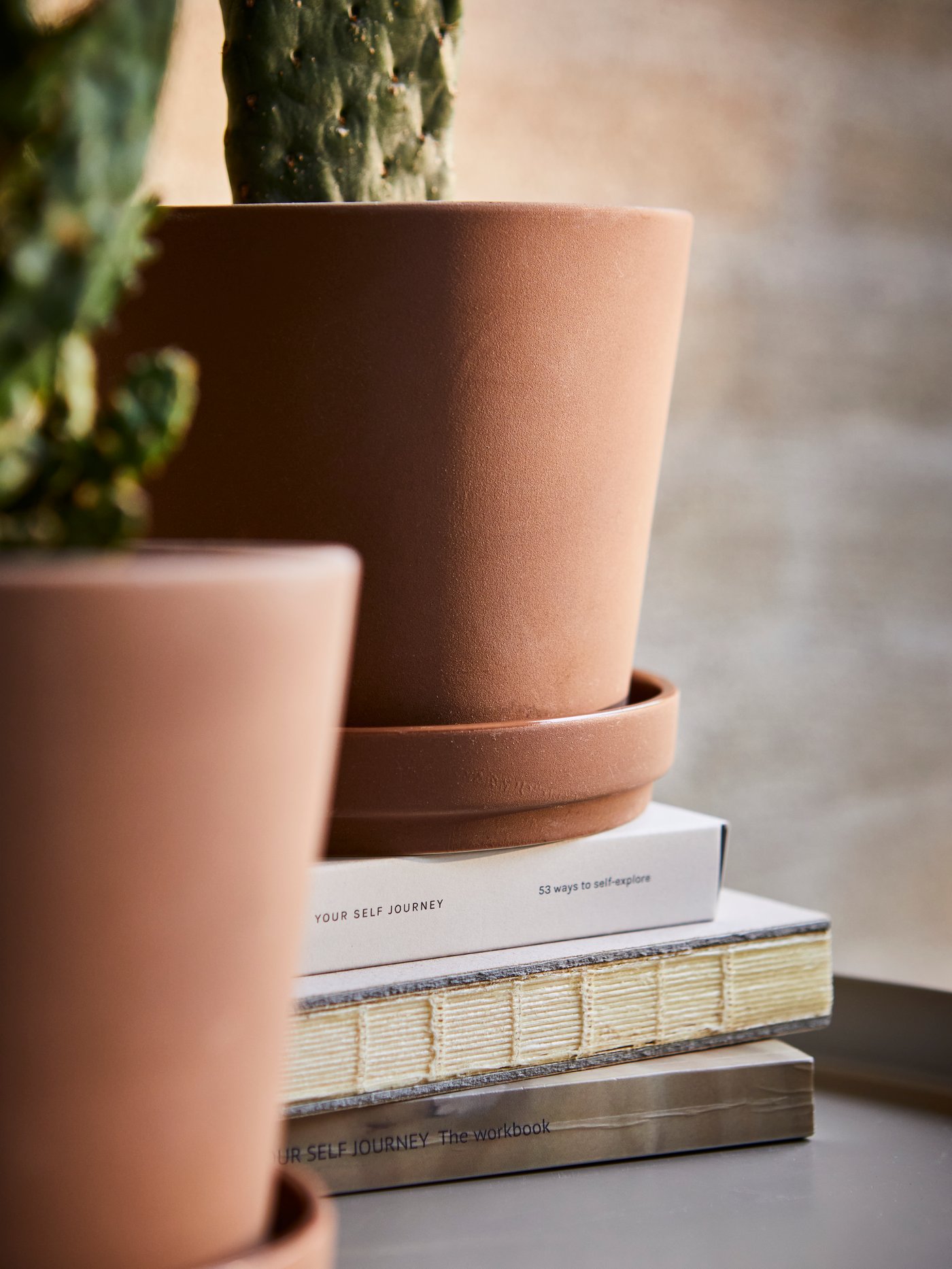 An in/outdoor brown KLARBÄR plant pot with saucer