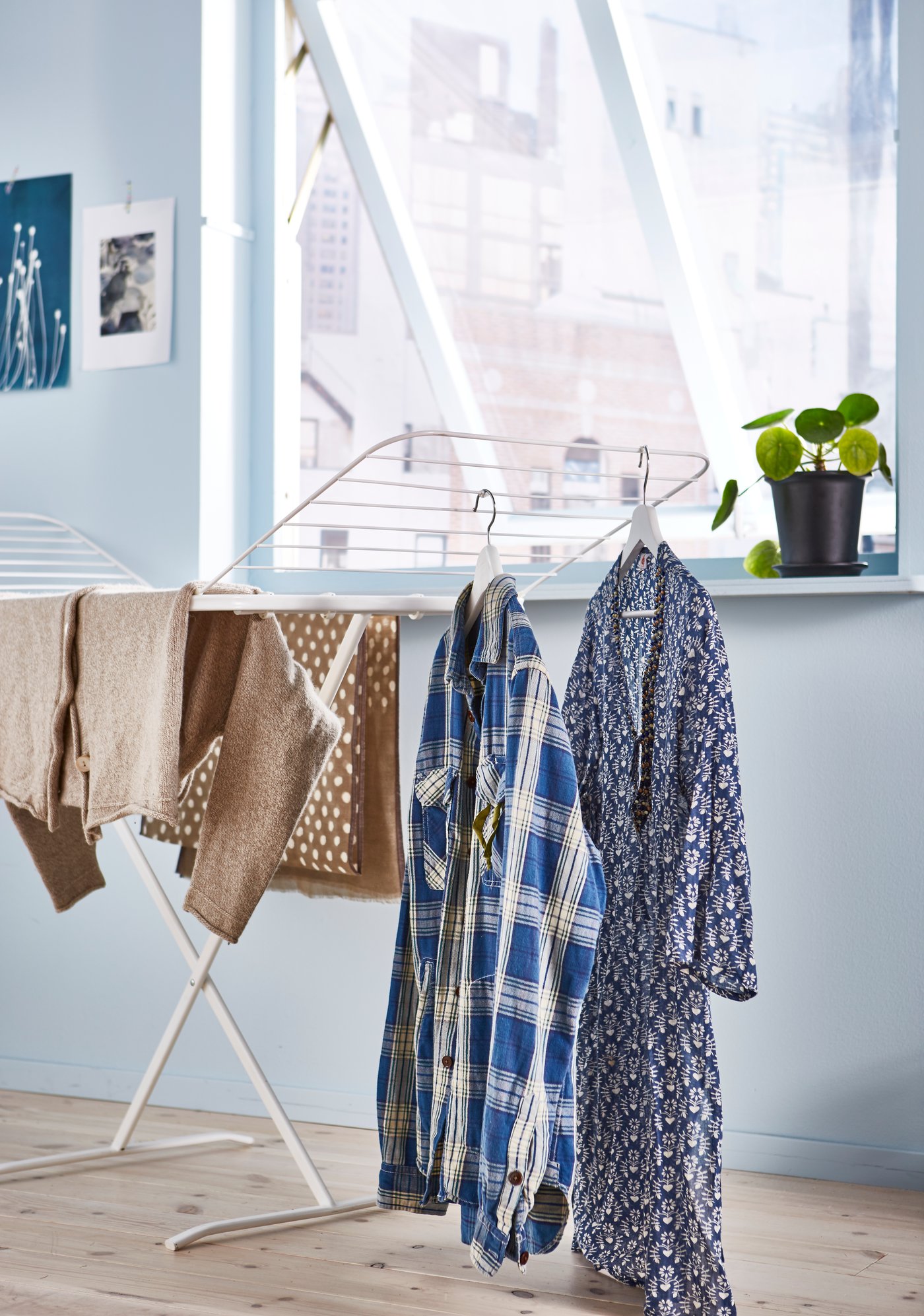A white MULIG drying rack, in/outdoor in the laundry room