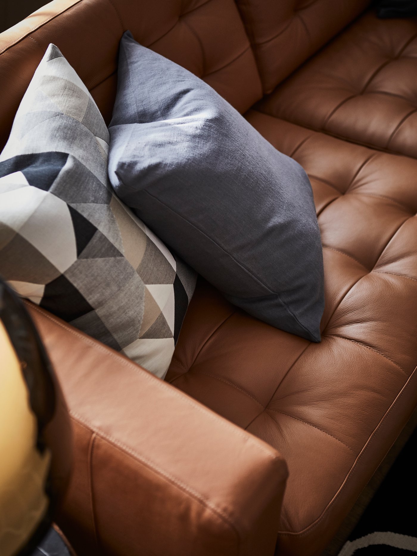 A beige SVARTHÖ cushion cover in the living room