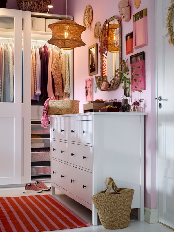 White HEMNES chest of drawers along wall to the right, PAX/GRIMO wardrobe in back, lots of art and mirrors on the wall.