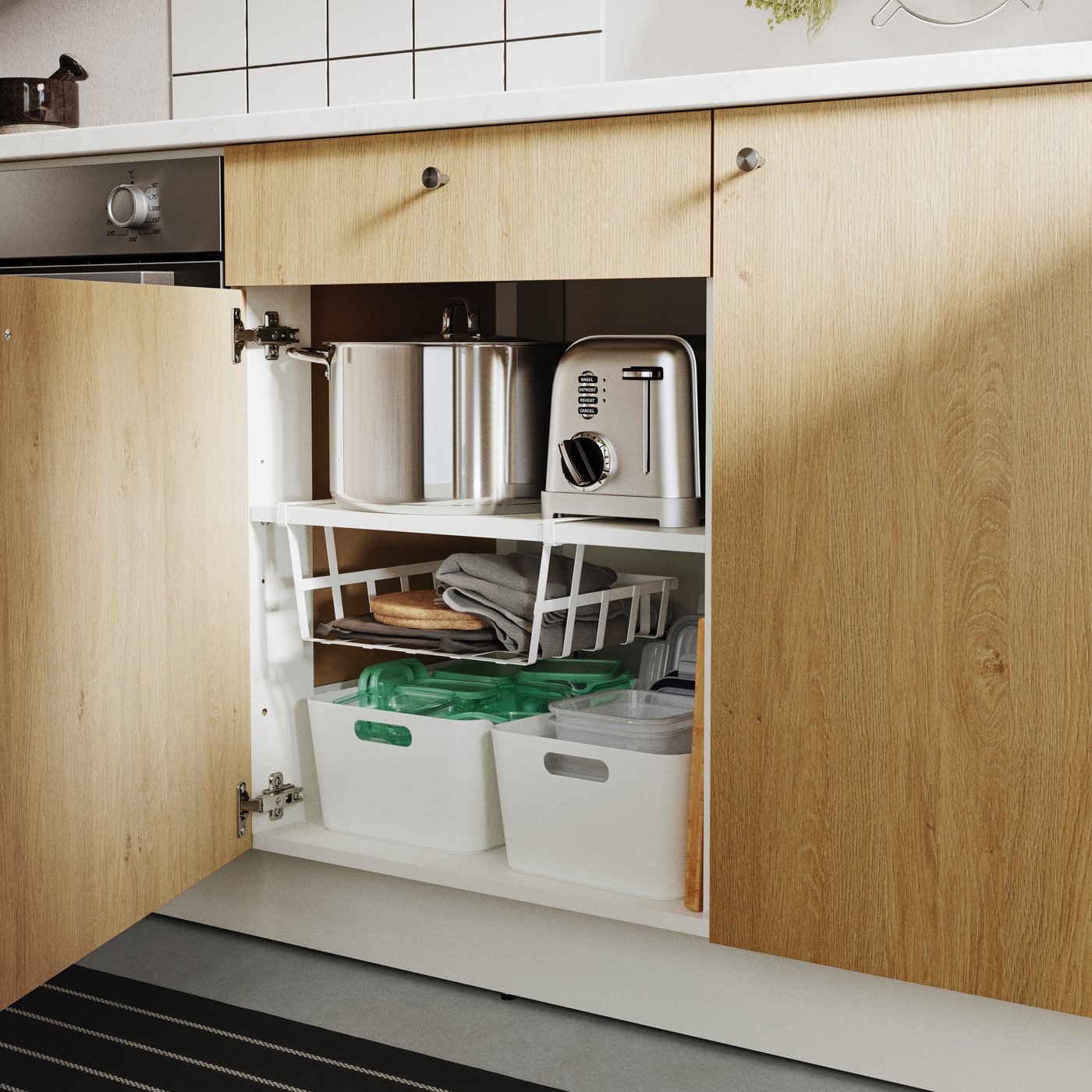 A KNOXHULT base cabinet with doors and a drawer, showcasing various kitchen items in a modern kitchen setting.