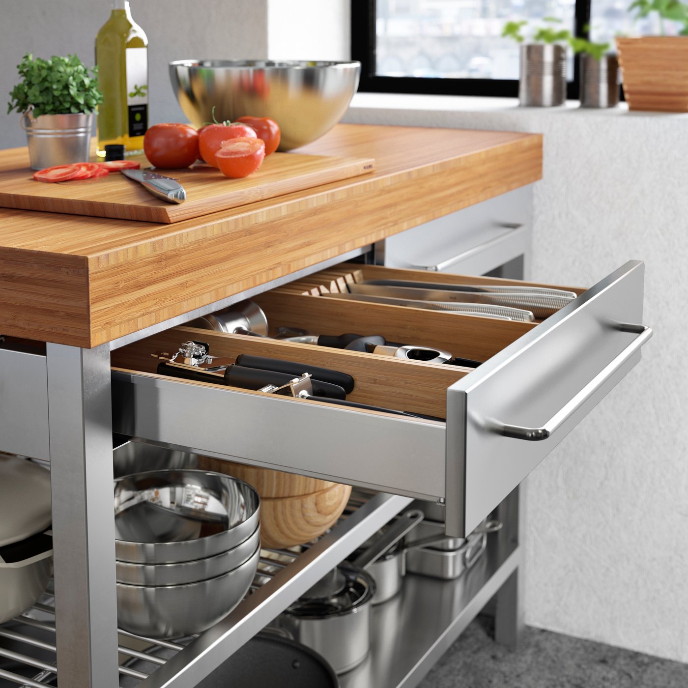 A stainless steel/bamboo RIMFORSA work bench in the kitchen