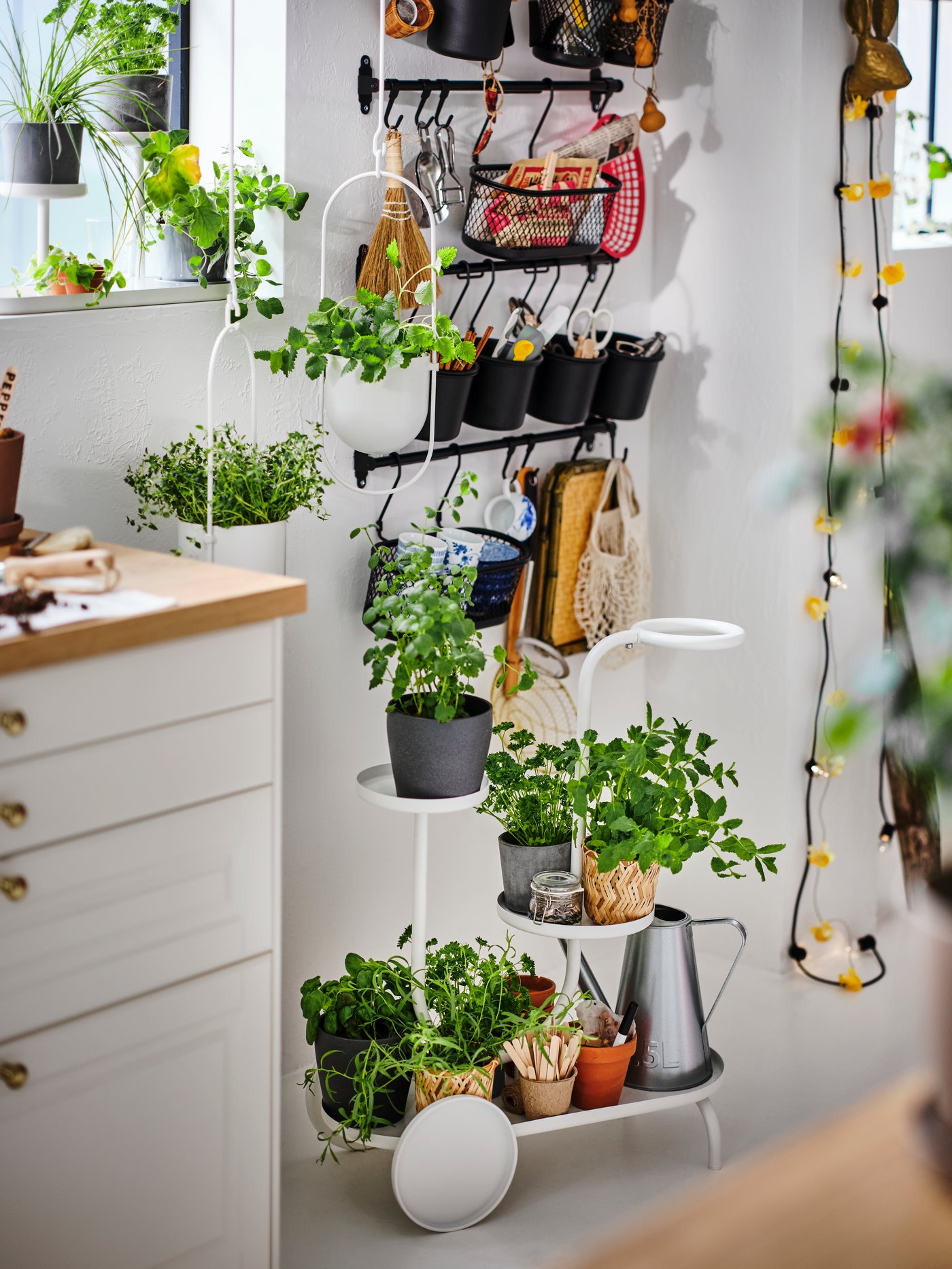 A white CHILISTRÅN plant stand with wheels