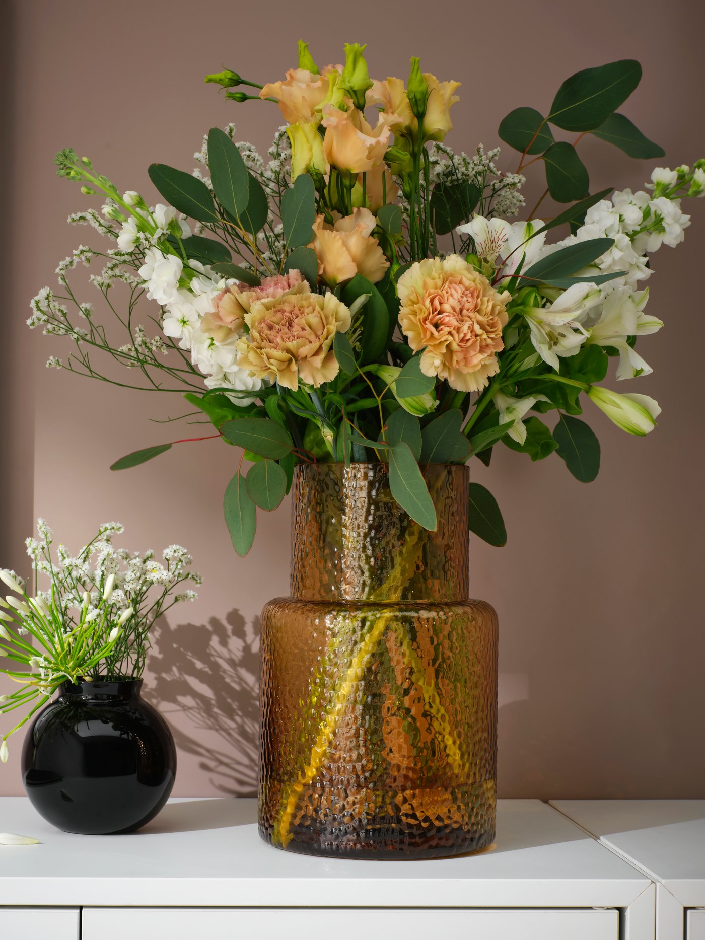 A patterned/brown KONSTFULL vase in the hallway