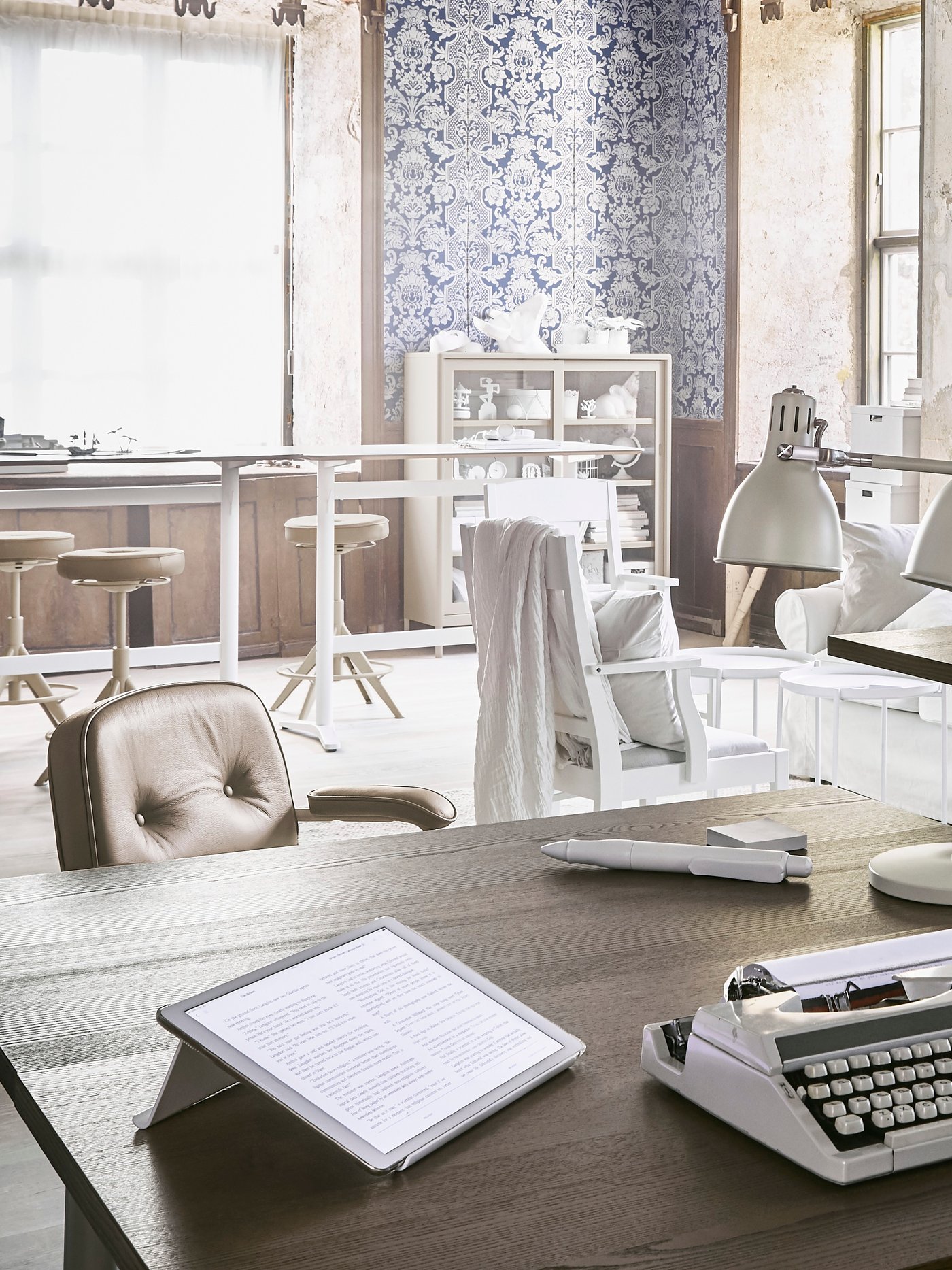 An open office in a loft with bright, industrial-style office furniture.