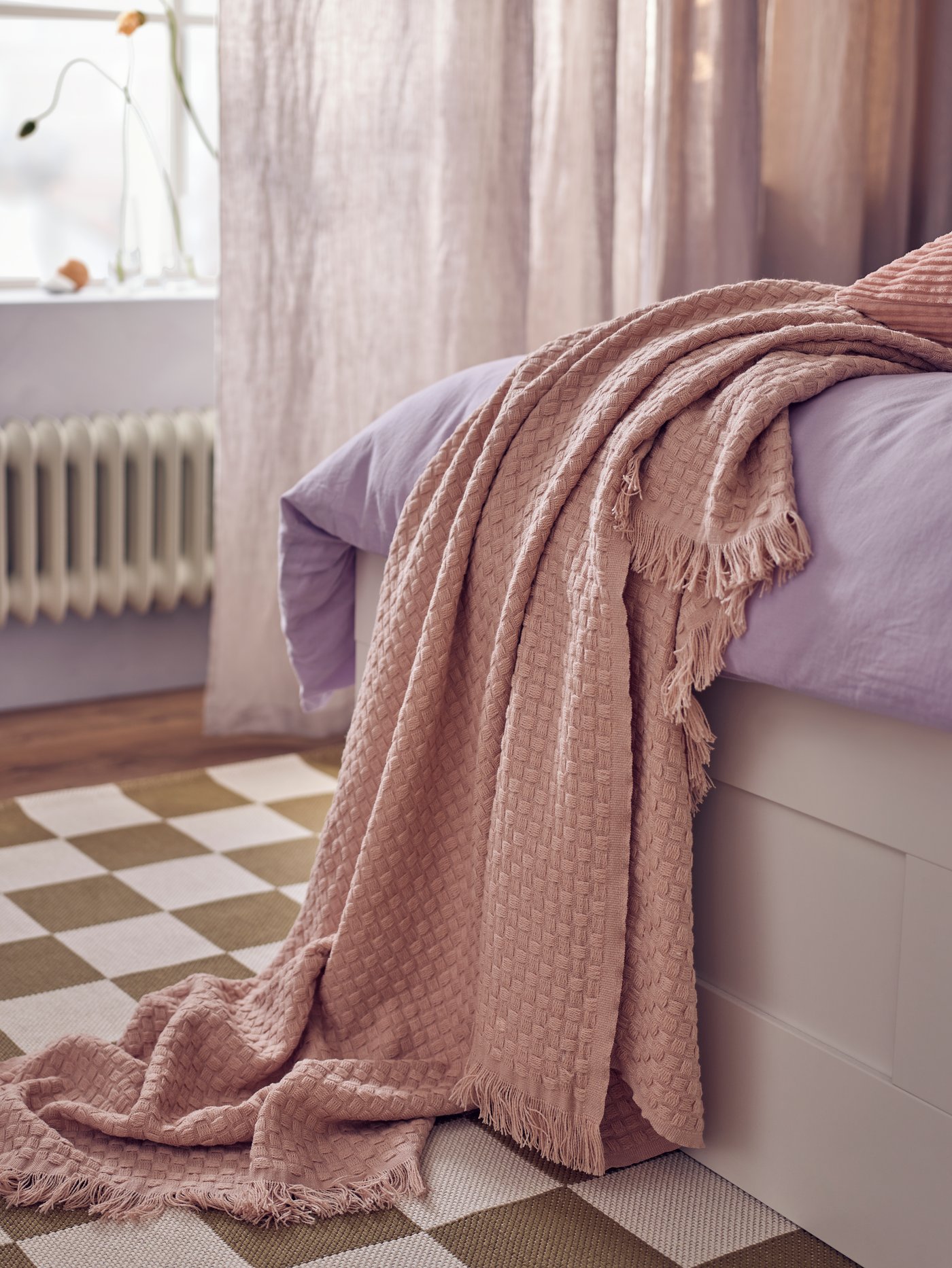 A light pink HORNMAL throw