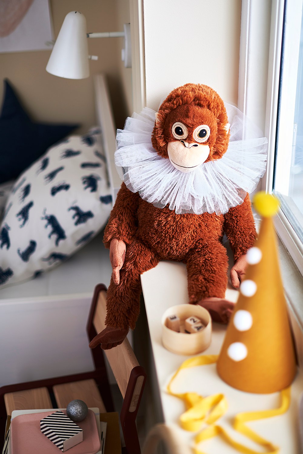 An orangutan DJUNGELSKOG soft toy in the childrens room.