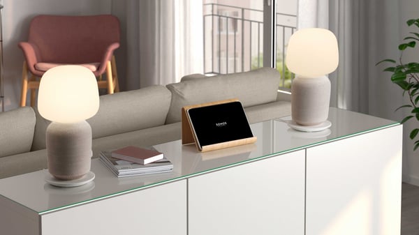 Two SYMFONISK table lamp with WiFi speaker units placed on a cabinet to create a stereo pair.