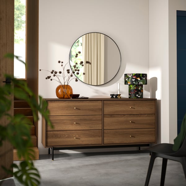 A brown walnut effect RÅDMANSÖ chest of 6 drawers in the hallway