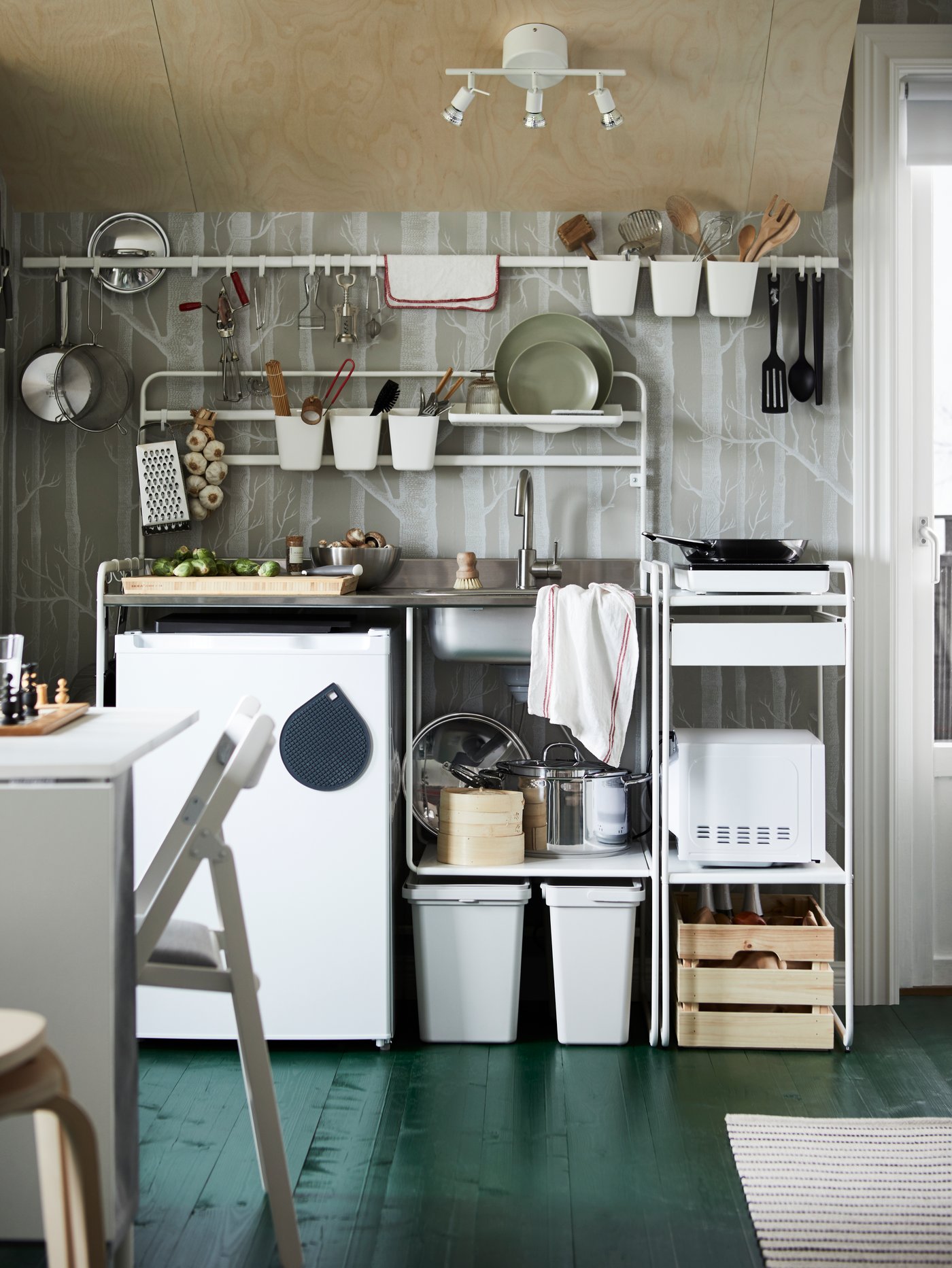 Small white SUNNERSTA kitchenette with a under counter fridge, a sink and a portable induction hob