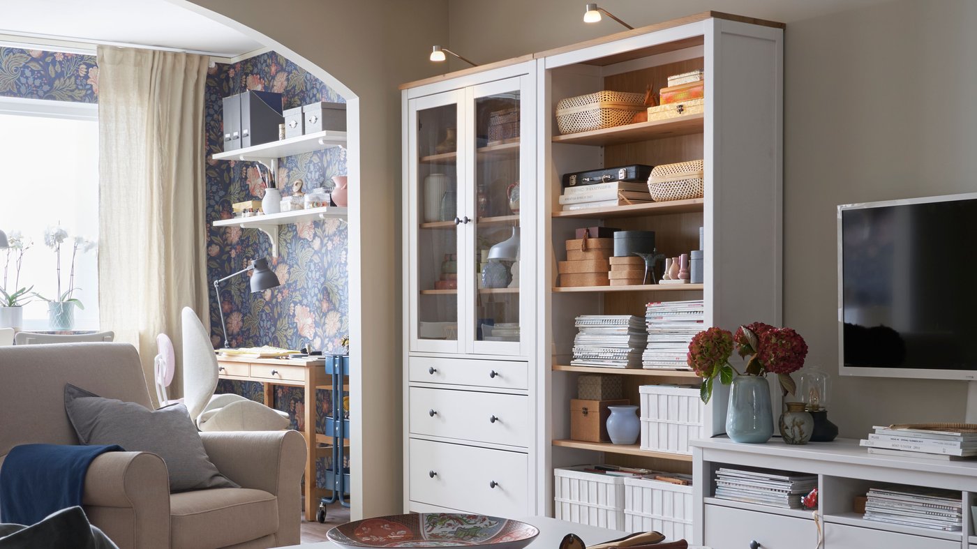 A white stain/light brown HEMNES bookcase in the living room