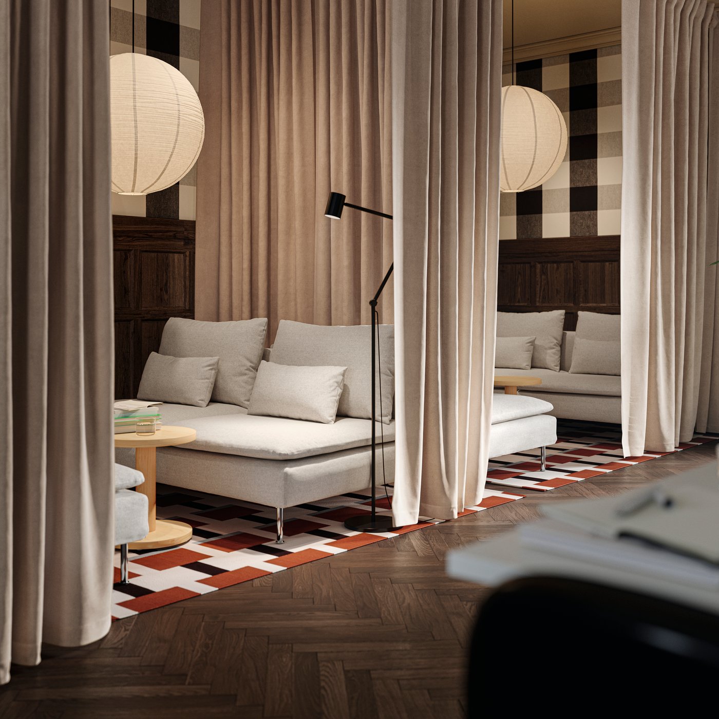 A break room with four beige/metal SÖDERHAMN sofas, two geometric rugs, and beige SANELA curtains closing off the space.