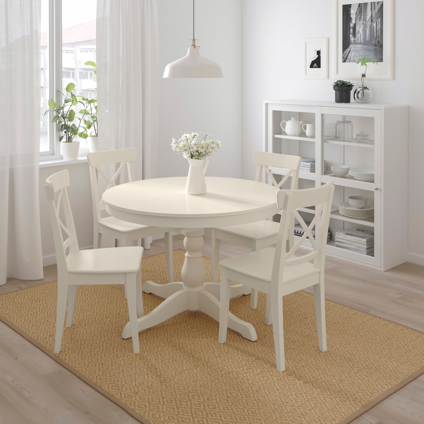 INGATORP round dining table with 2 chairs around it on top of a flatwoven rug in the dining room