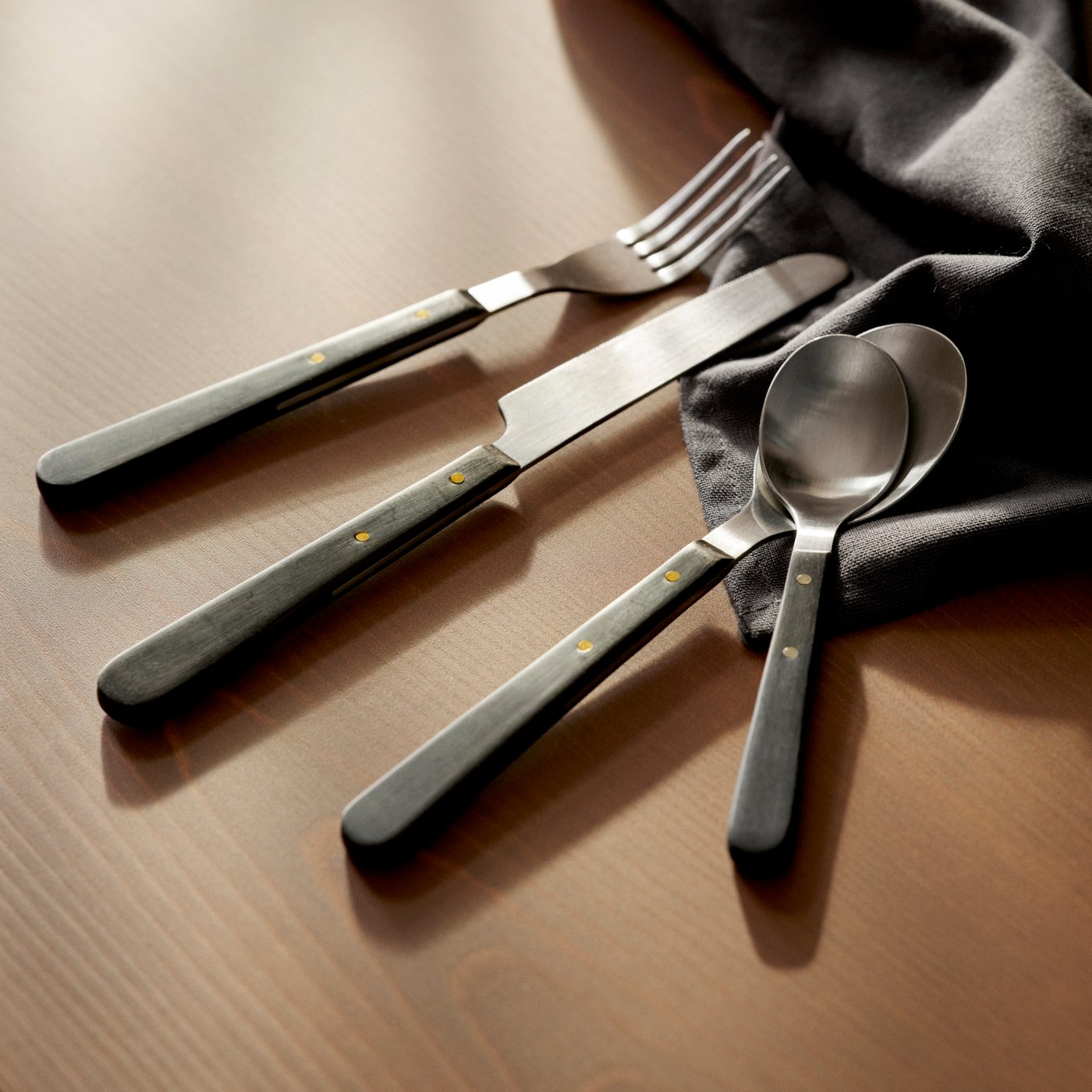 A black DOFTSKÖLD 24-piece cutlery set
