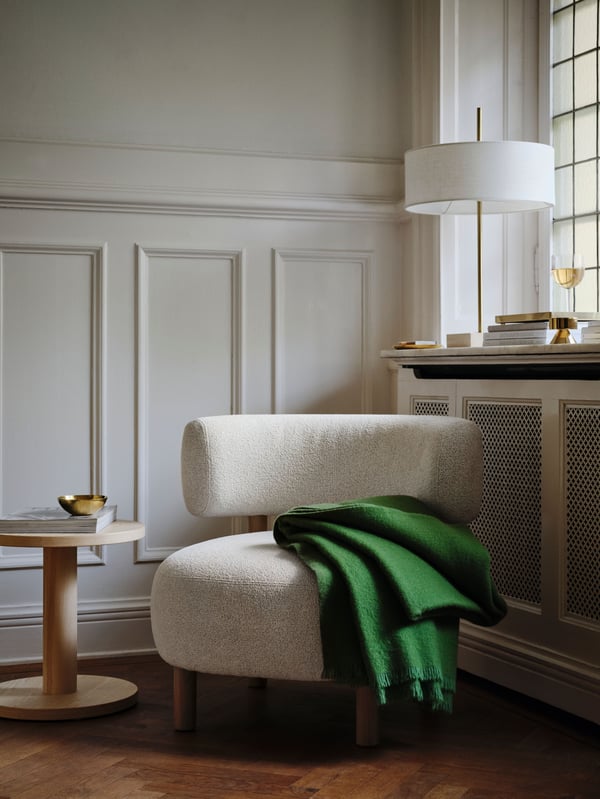 A brass-colour STOCKHOLM 2025 candlestick/tealight holder in the living room