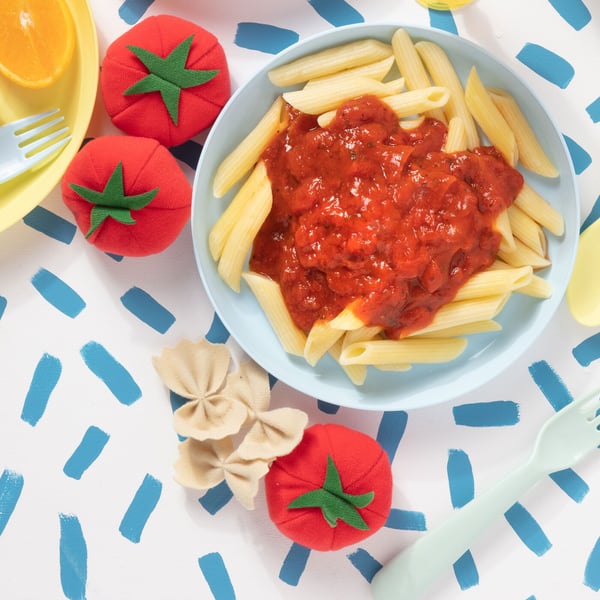 A plate of mezze penne pasta with tomato sauce for kids.
