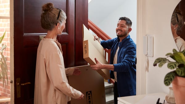 A customer receiving a package at the door.