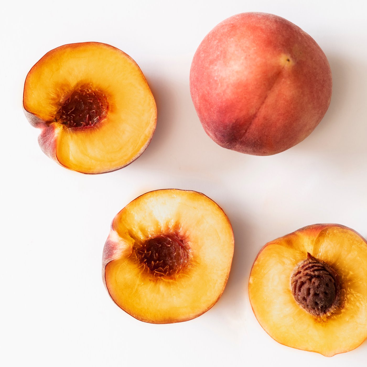 A Peach light orange LOTSFÅGEL scented candle in glass in the NA