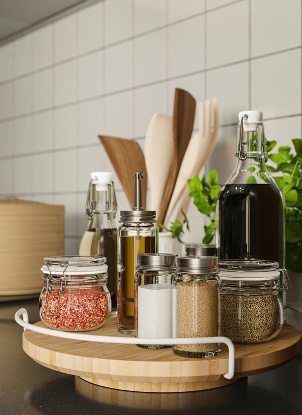APTITLIG lazy susan on a kitchen counter, neatly displaying kitchen essentials such as spices, oil bottles, and utensils.