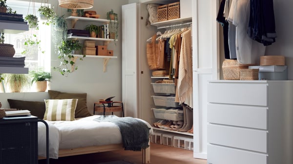 Bedroom with open wardrobe and drawers