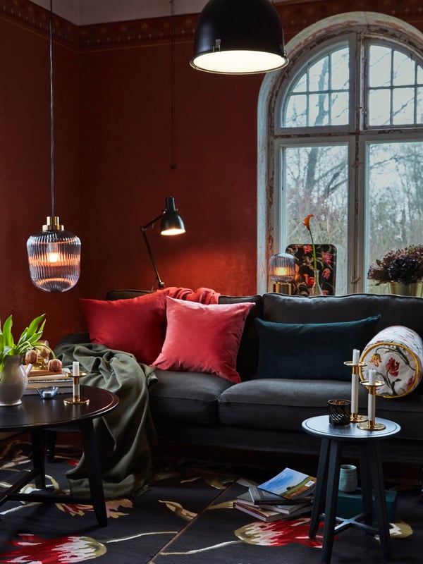 In a living room, a mix of ceiling, pendant, floor and table lamps help create a warm and cozy mood.