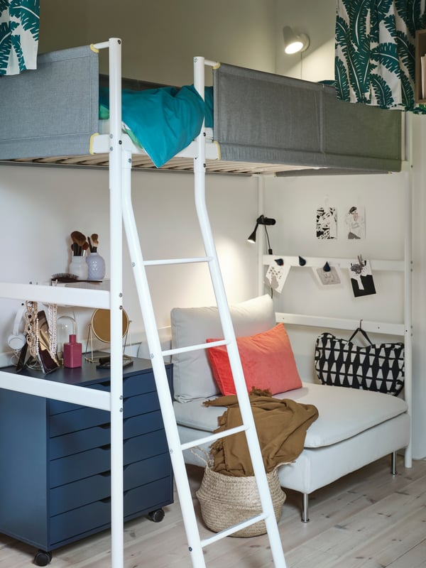 A SÖDERHJAMN 1-seat sofa section and a blue ALEX drawer unit with castors stand under a white VITVAL loft bed.