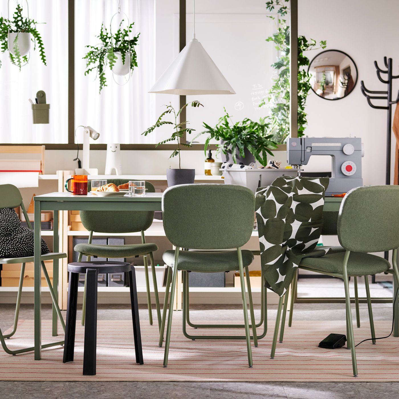 VIHALS chairs and a stool stand at a green VIHALS extendable table on a rug in a multifunctional dining room.