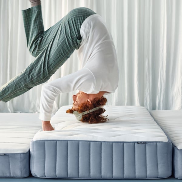A firm/light blue VALEVÅG pocket sprung mattress
