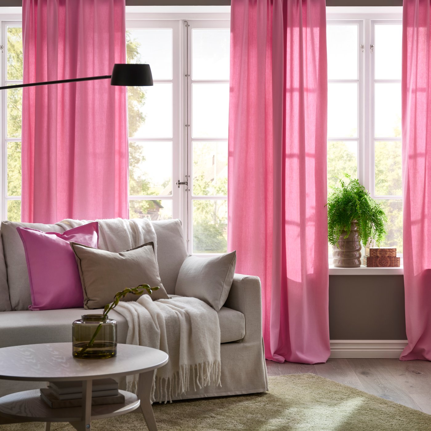 A pink GURLI cushion cover and pink GINTSMOTT curtains in the living room ready for Deepavali celebrations