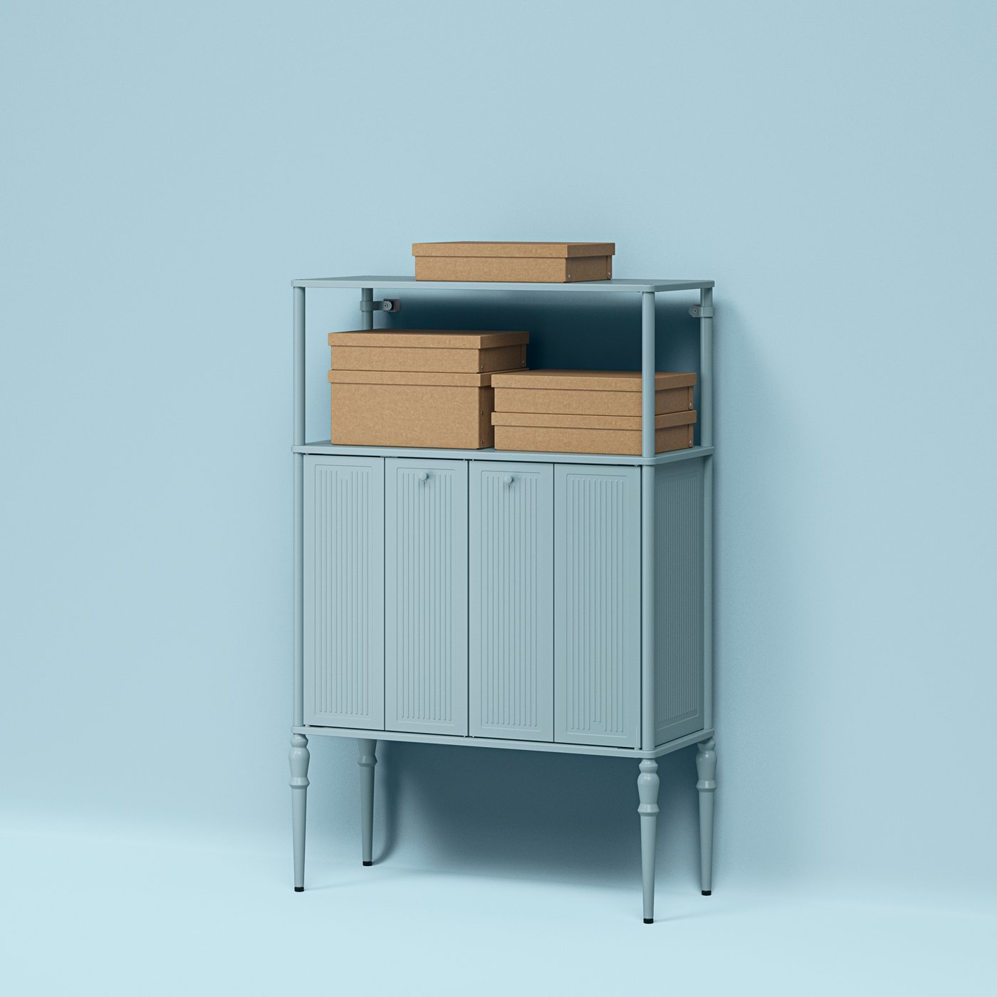 GÄRDESGÅRD storage boxes with lids stacked on the shelf of a light-grey-blue SÅGMÄSTARE cabinet against a blue background.